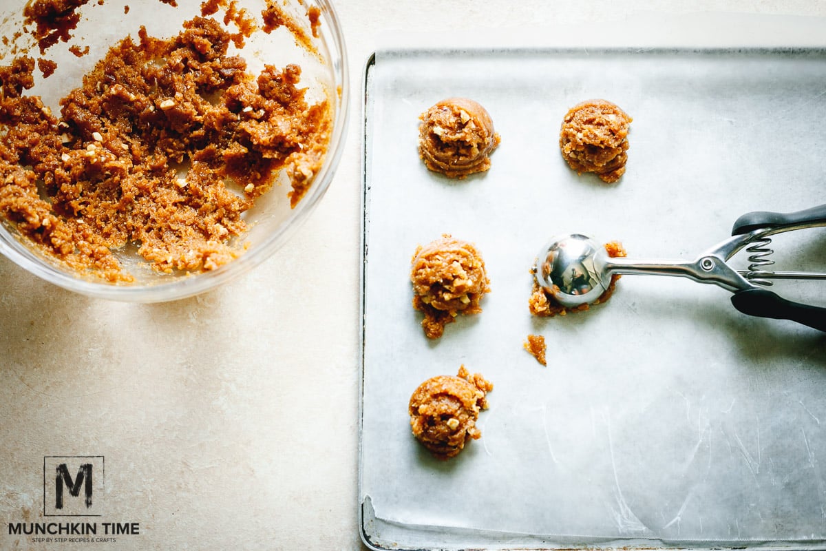 Scoop out almond cookie dough onto the baking sheet.