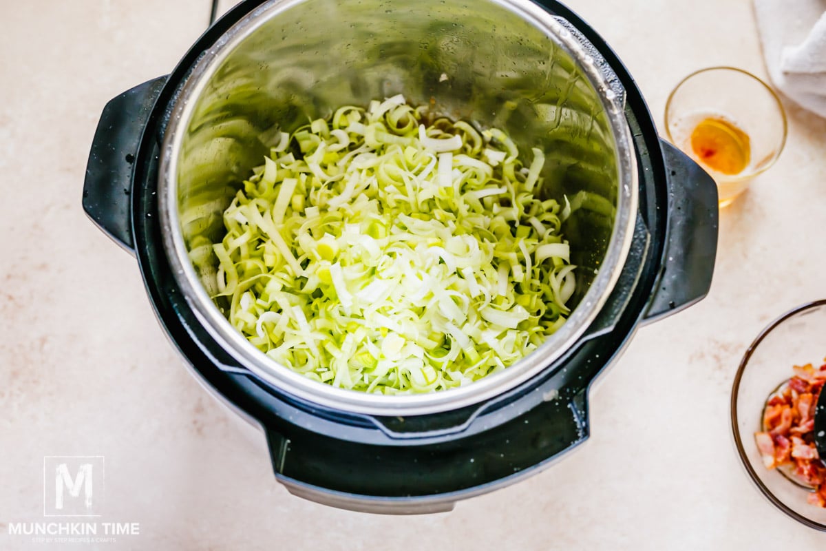Saute chopped leeks for 5 minutes inside Instant Pot.