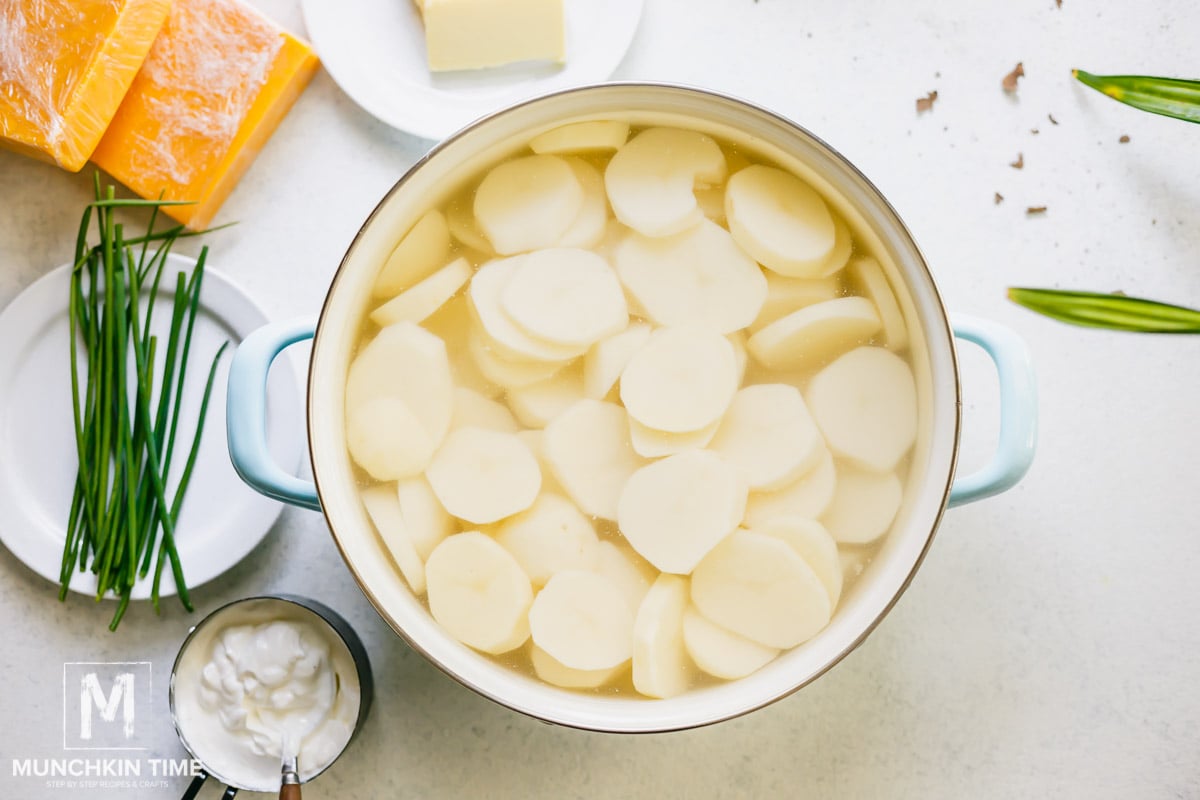 Sliced potato inside the pot filled with water.