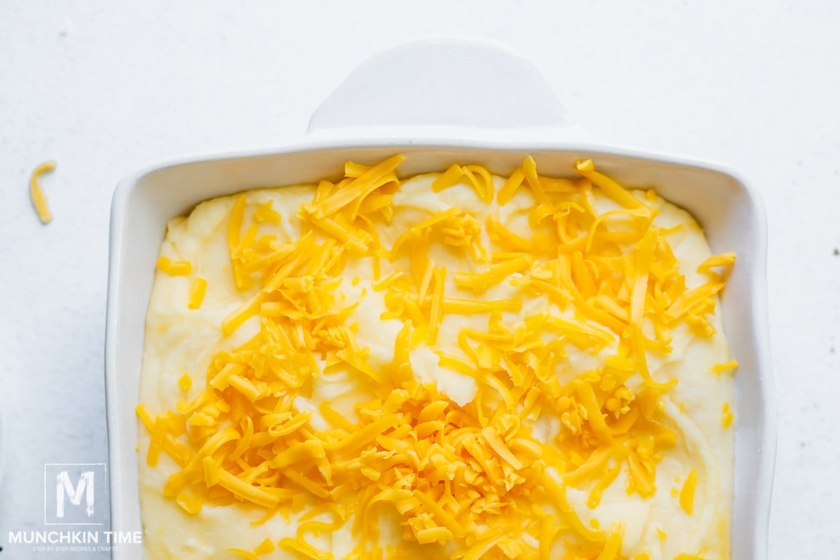 A casserole with mashed potatoes and cheese on top.