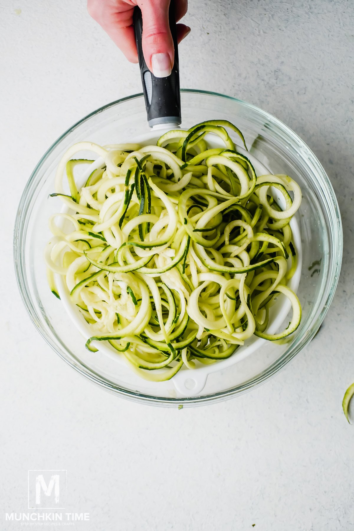 Zucchini noddles salted and draining. 