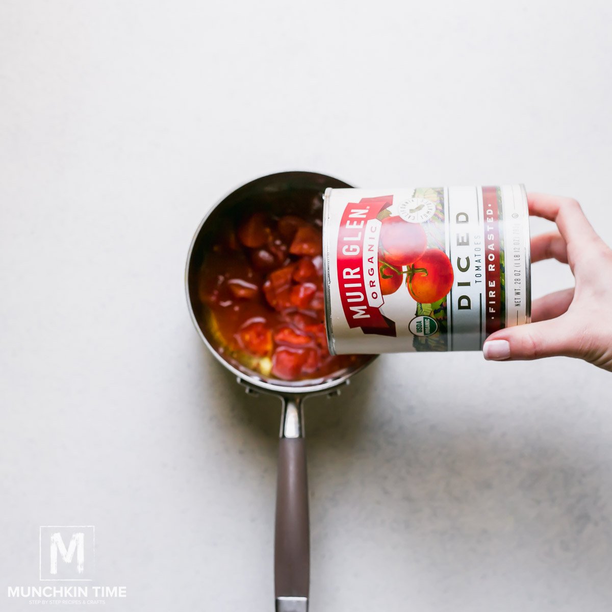 Muir Glen tomatoes added to the sauce pan. 