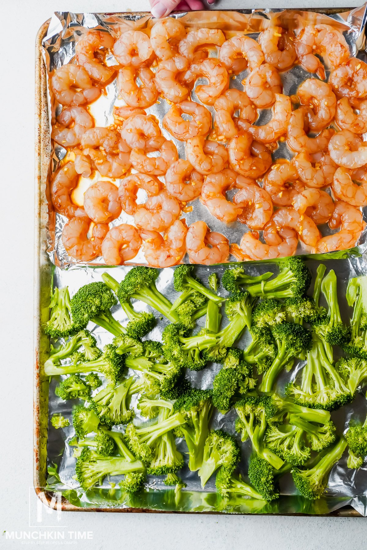 Honey Garlic Shrimp with Broccoli broccoli placed on a baking sheet lined with foil paper, ready for baking. 