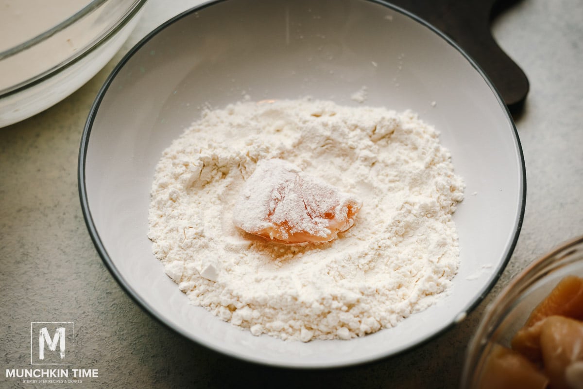 Chicken piece dusted in flour.