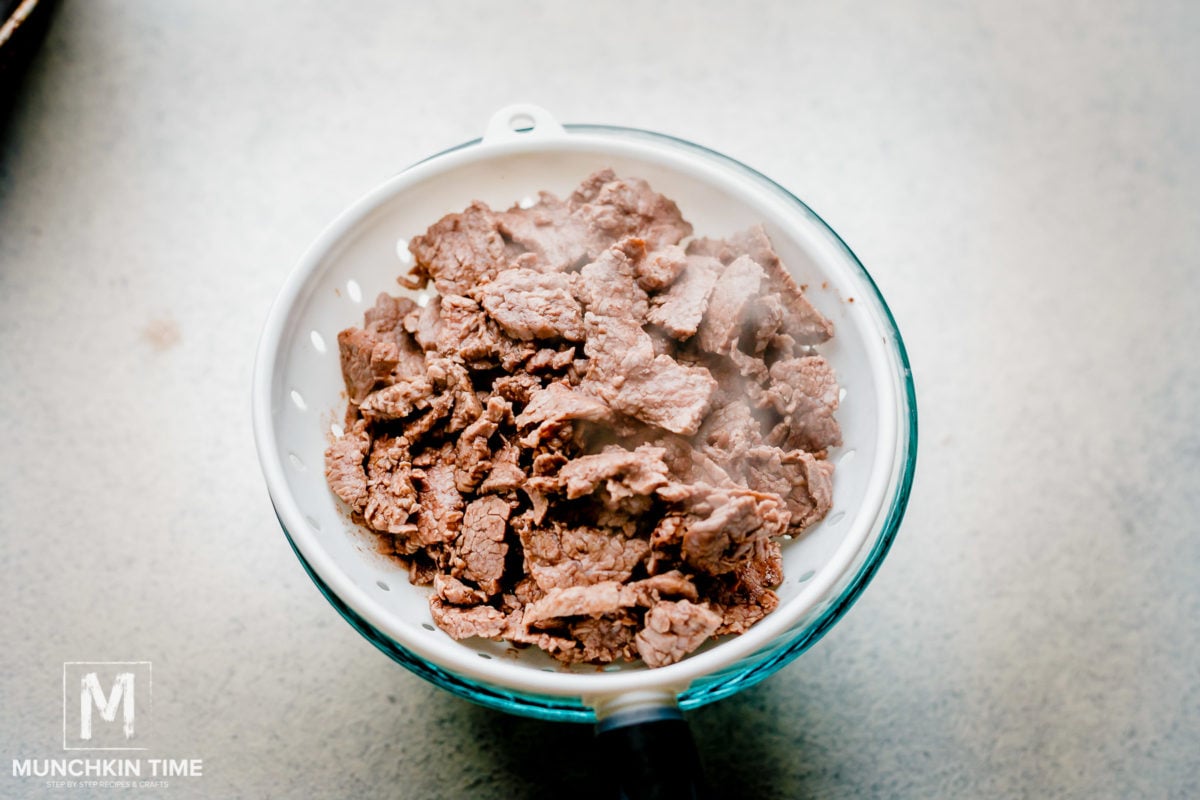 Beef inside the colander, draining.