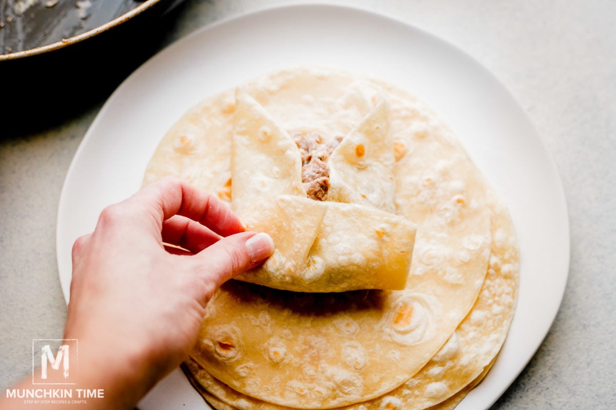 How to fold chimichangas. Place filling in the middle of the tortilla then fold the sides, follow by the bottom of the tortilla to the top.