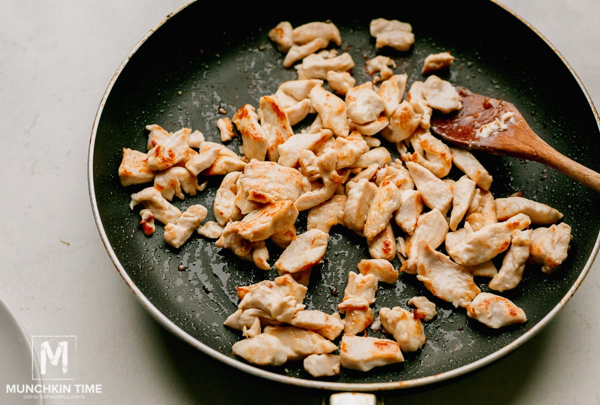 Chicken cooked inside large skillet.