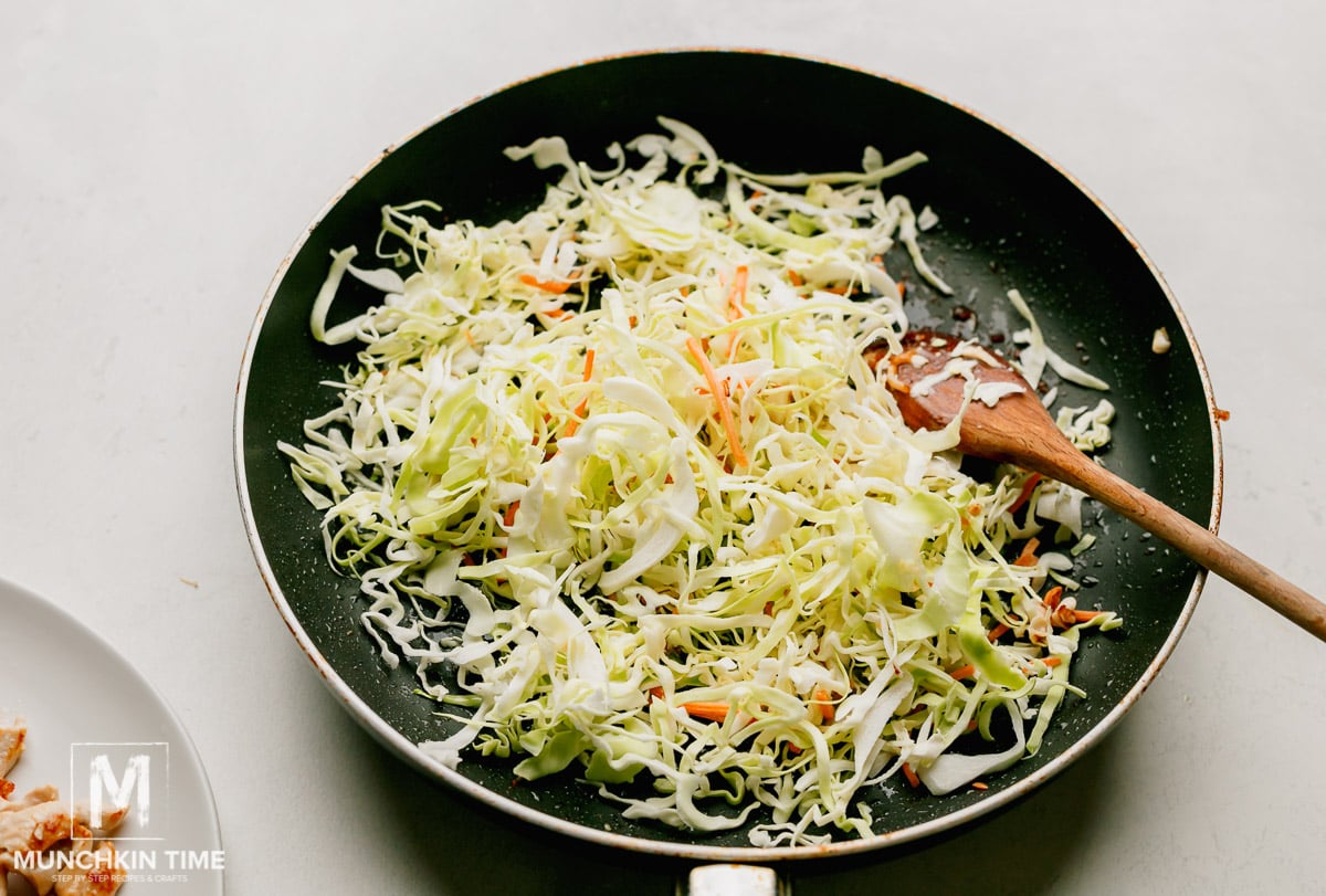 Cole slaw added to the large skillet with oil to make chow mein.