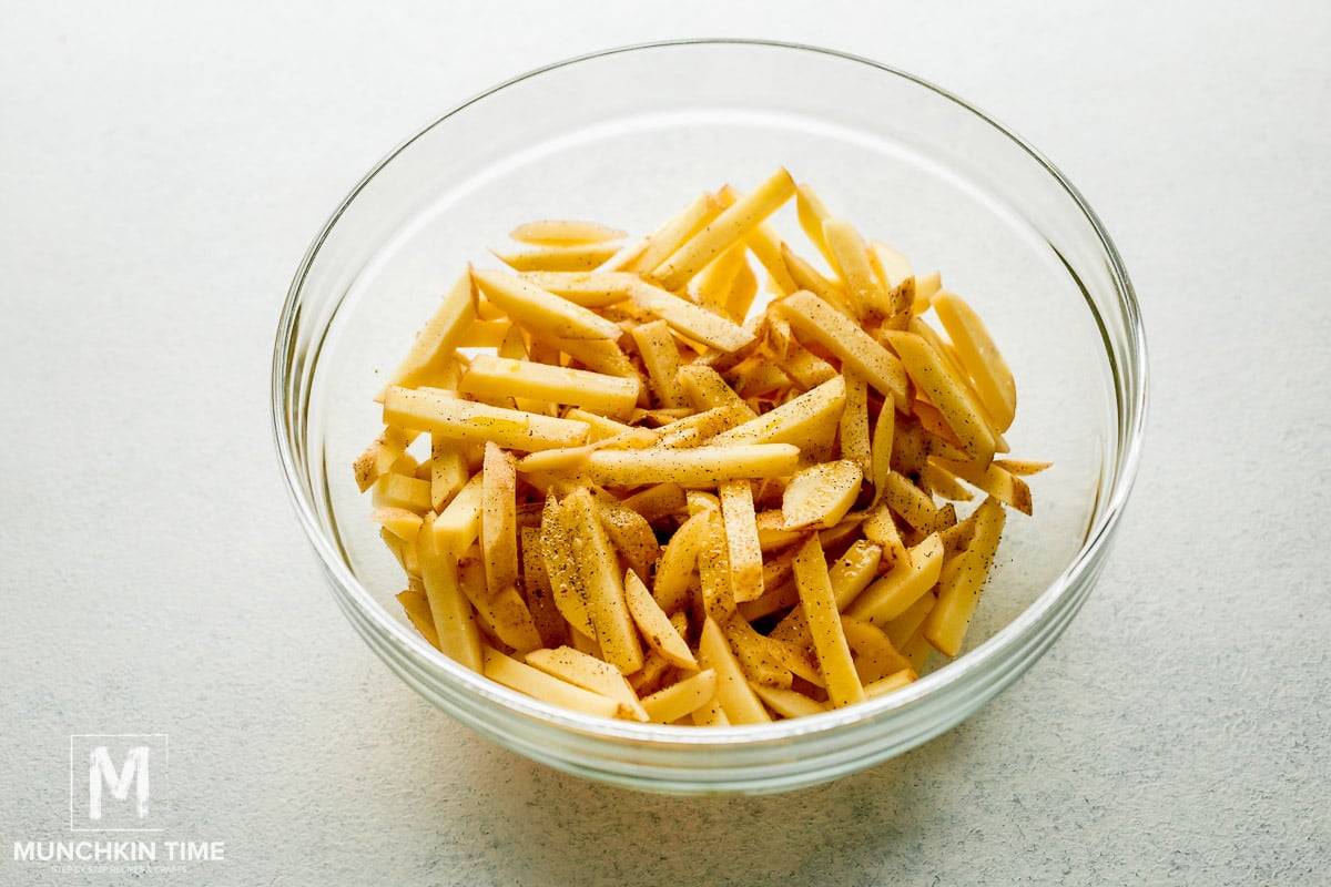 French fries season with oil, salt and pepper.