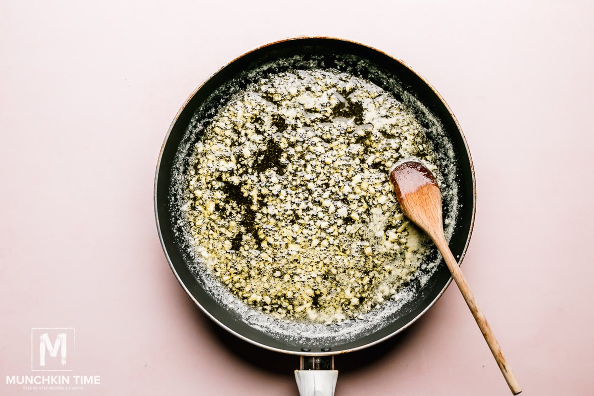 Melted butter in the skillet with garlic. 