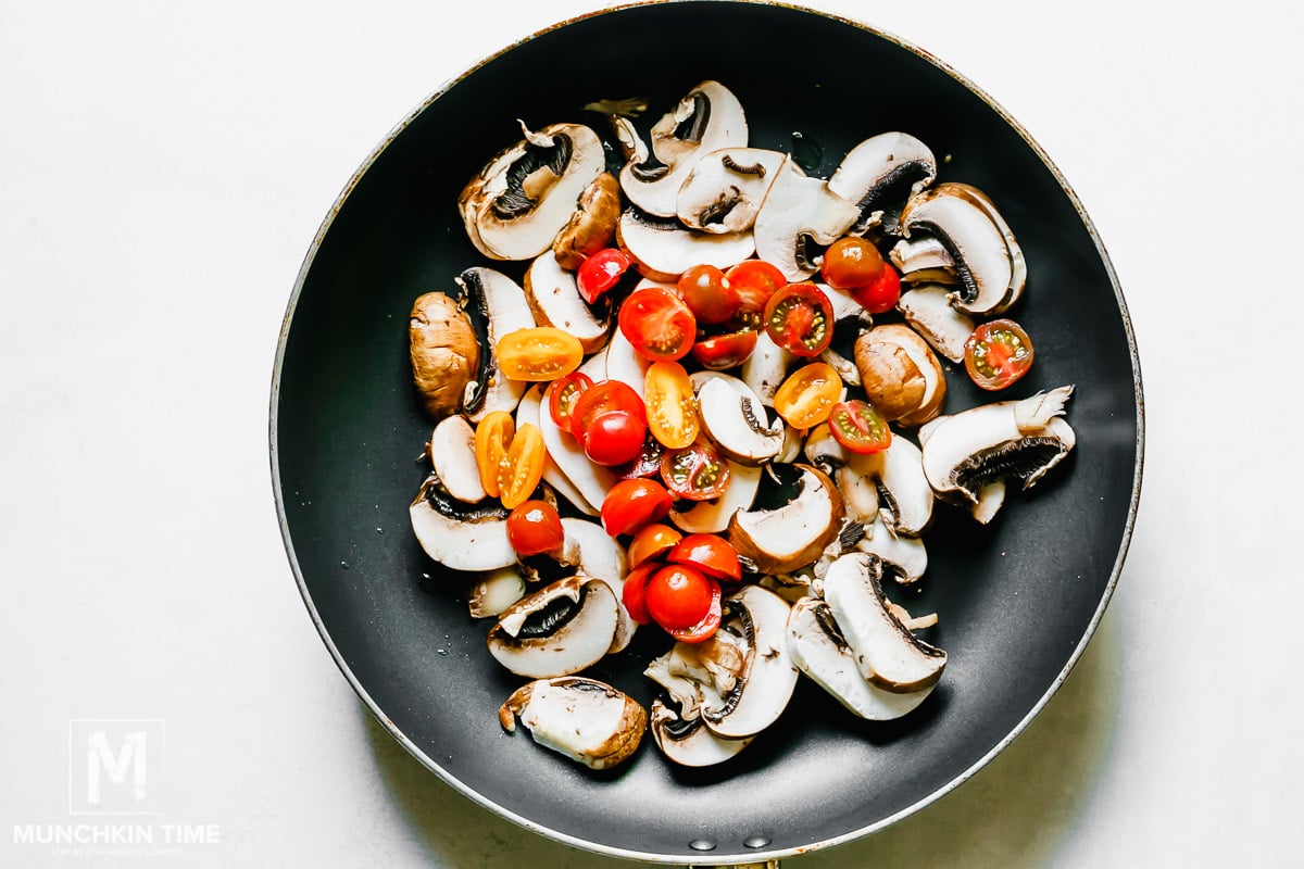 Skillet with mushroom and tomatoes.