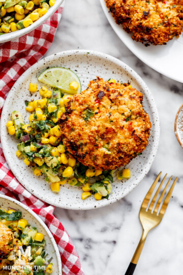 shrimp patties on a plate with corn salsa