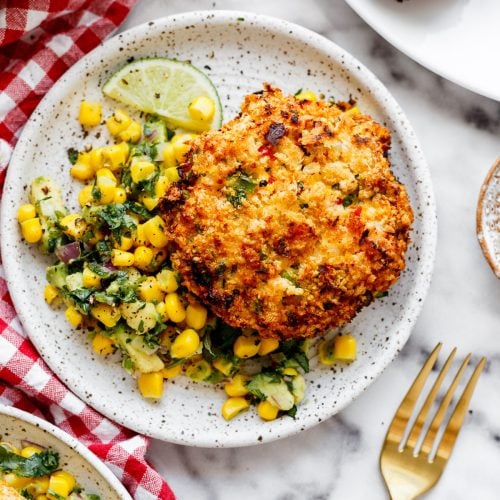 shrimp patties on a plate with corn salsa