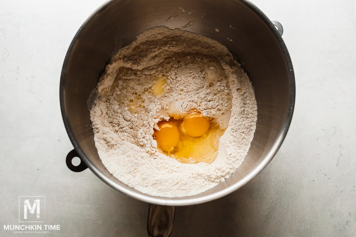 Dry and wet easter bread dough ingredients added to the bowl.