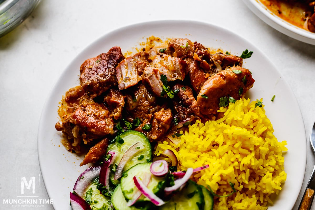 Braised Pork Shoulder with golden rice and cucumber salad.