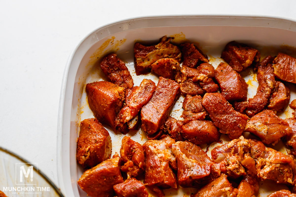 Seasoned Pork shoulder in a baking sheet ready for roasting.