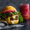 Homemade Burger Recipe with ground beef & ground pork, cheese, lettuce and pickled red onions.