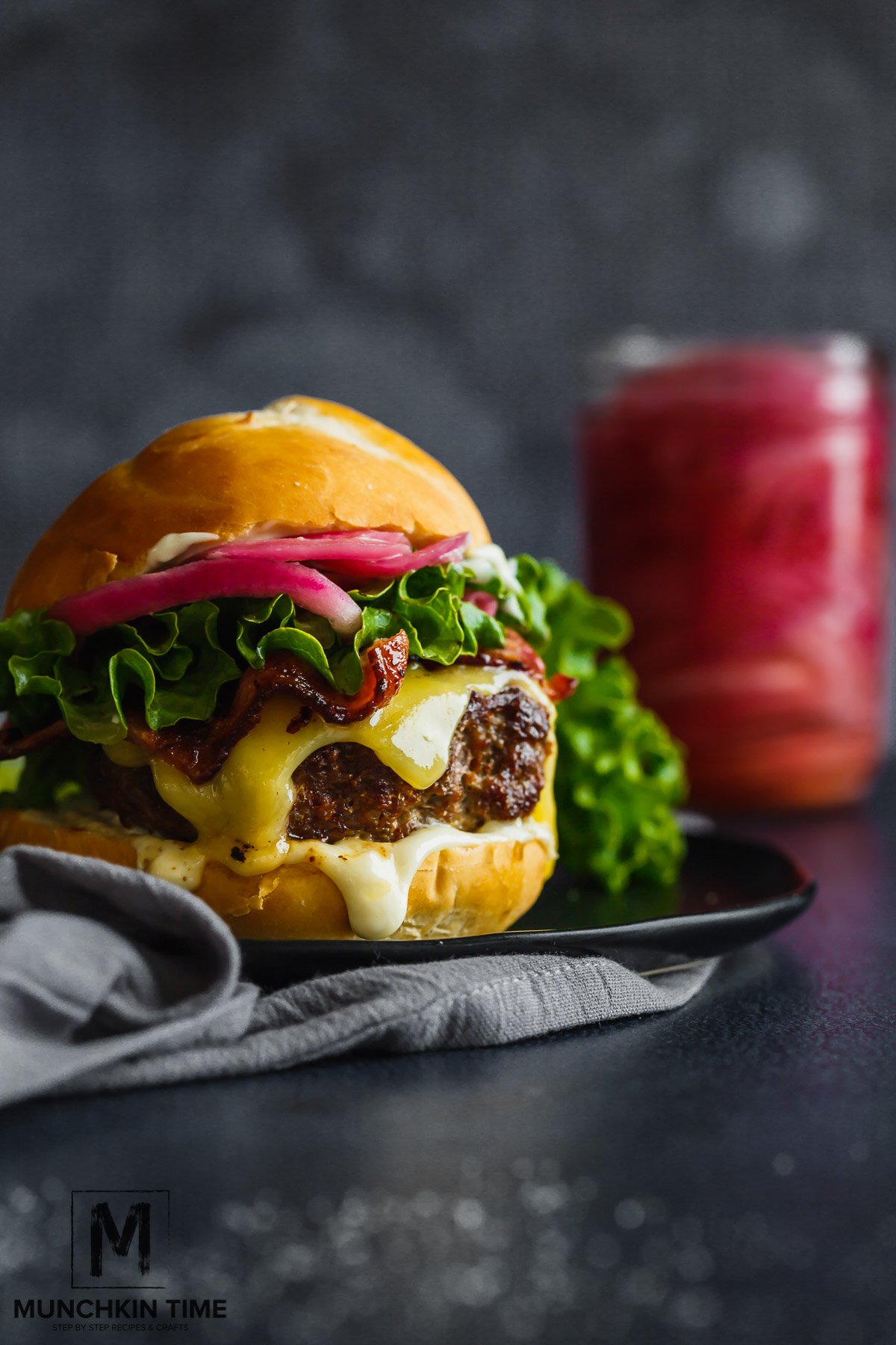 Ground beef & ground pork burger with cheese, lettuce and pickled red onions.