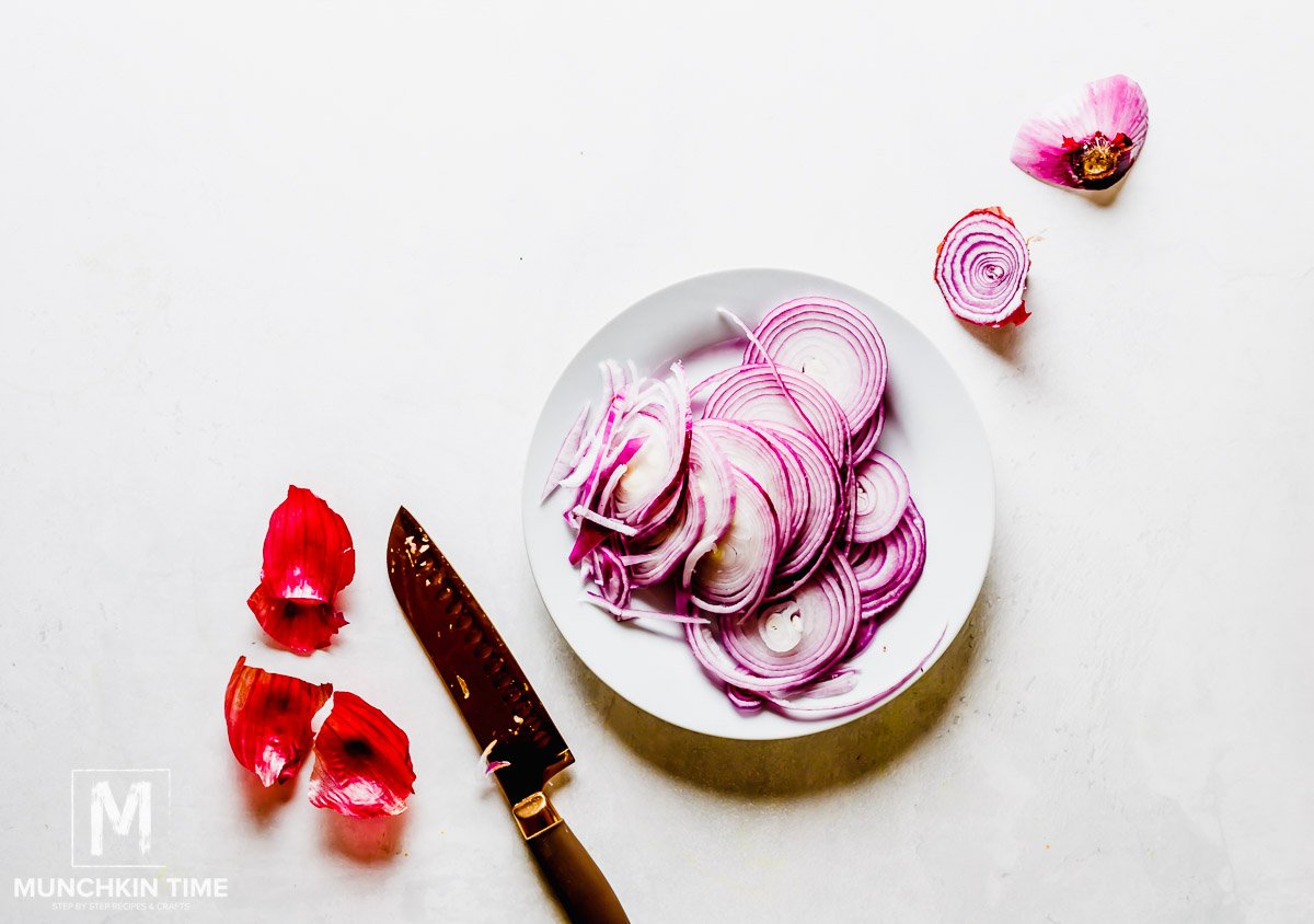 Red Onions sliced on a white big plate. 