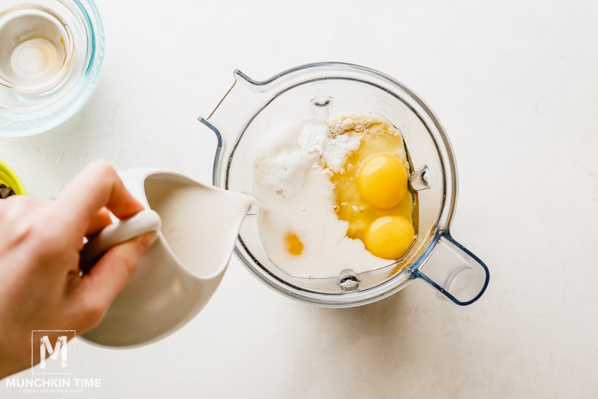 Making pancakes batter using a blender.