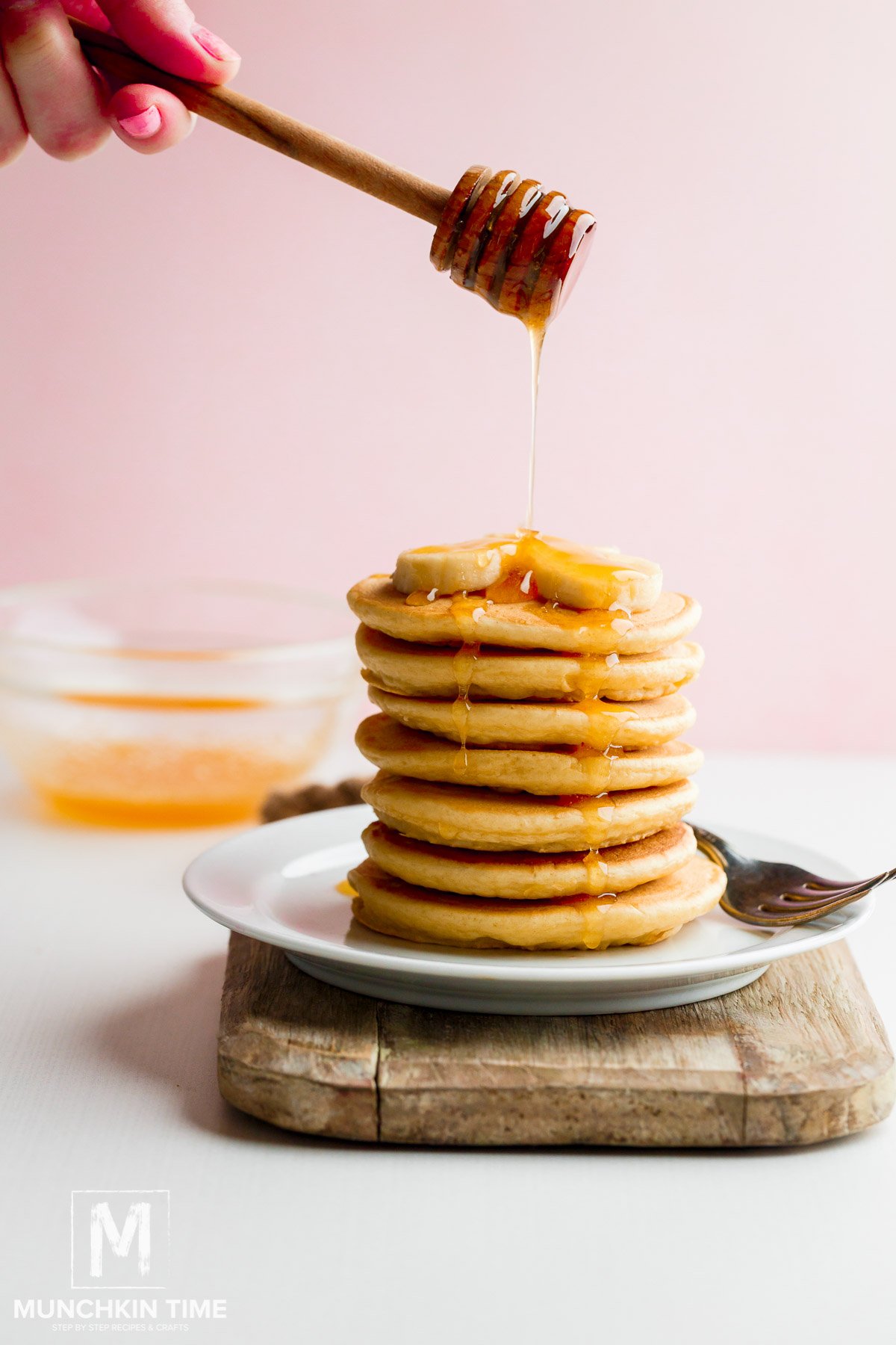 Quick & Easy Buttermilk Pancake Recipe with honey drizzle and banana slices. 