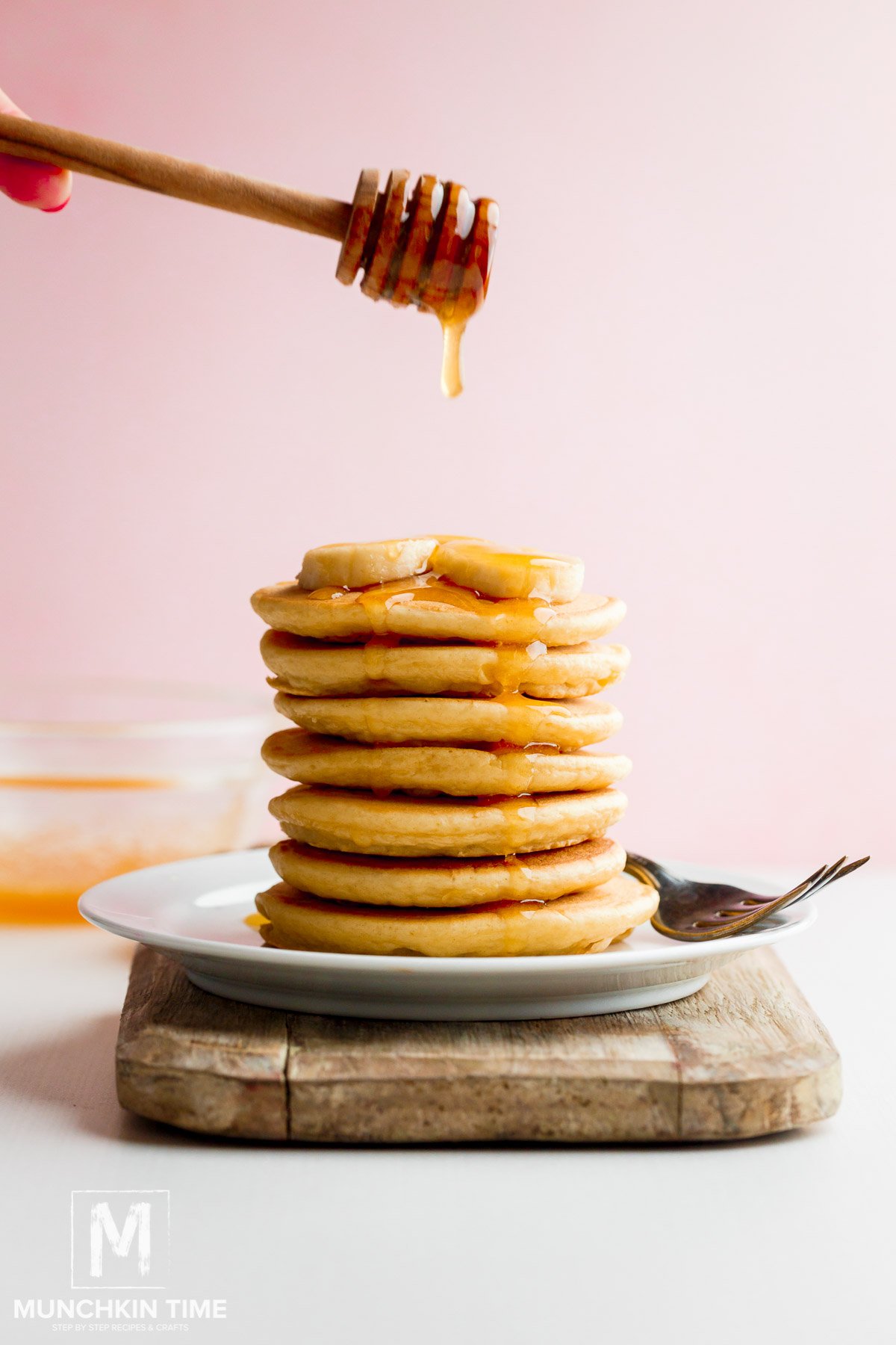 Quick & Easy Buttermilk Pancake Recipe with honey drizzle and banana slices.