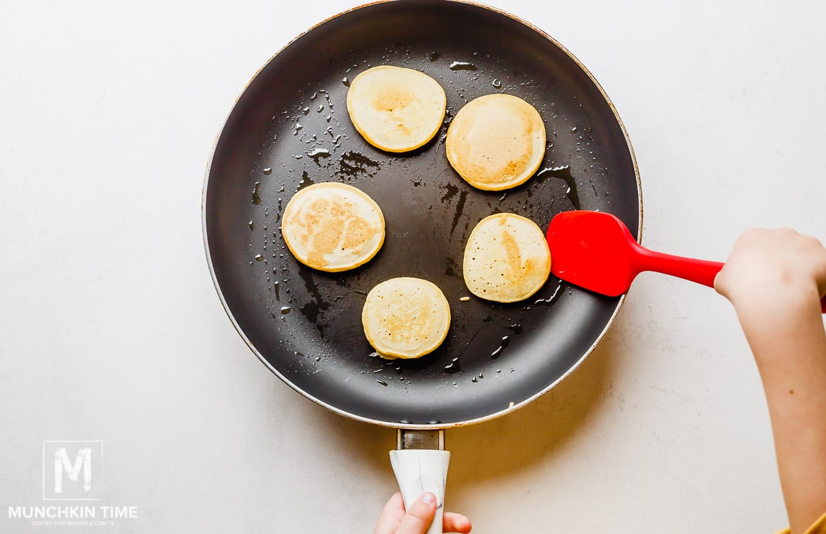 Homemade Pancakes cooking in the skillet.