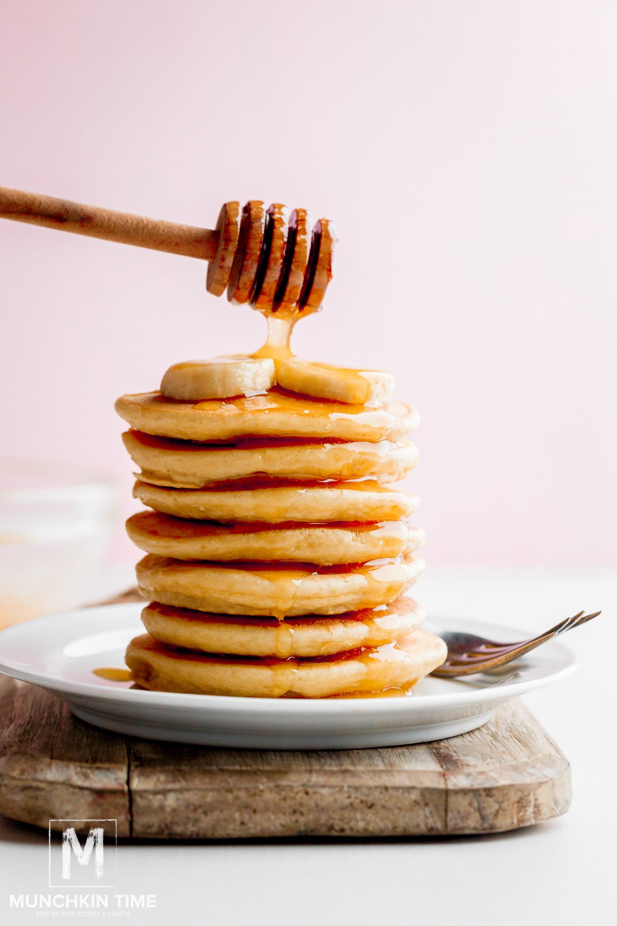 Quick & Easy Buttermilk Pancake Recipe with honey drizzle and banana slices.