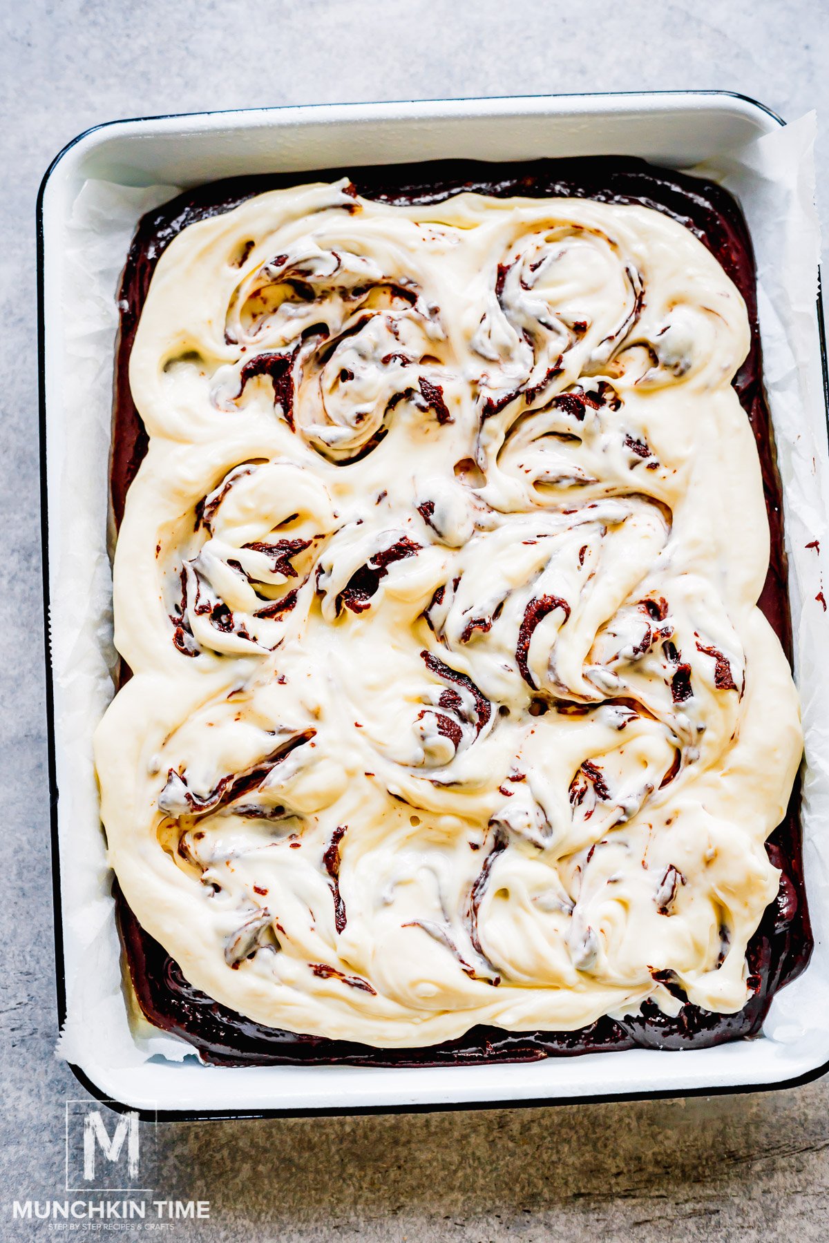 spoonful of brownie dough added on top of cheesecake topping and swirled in.