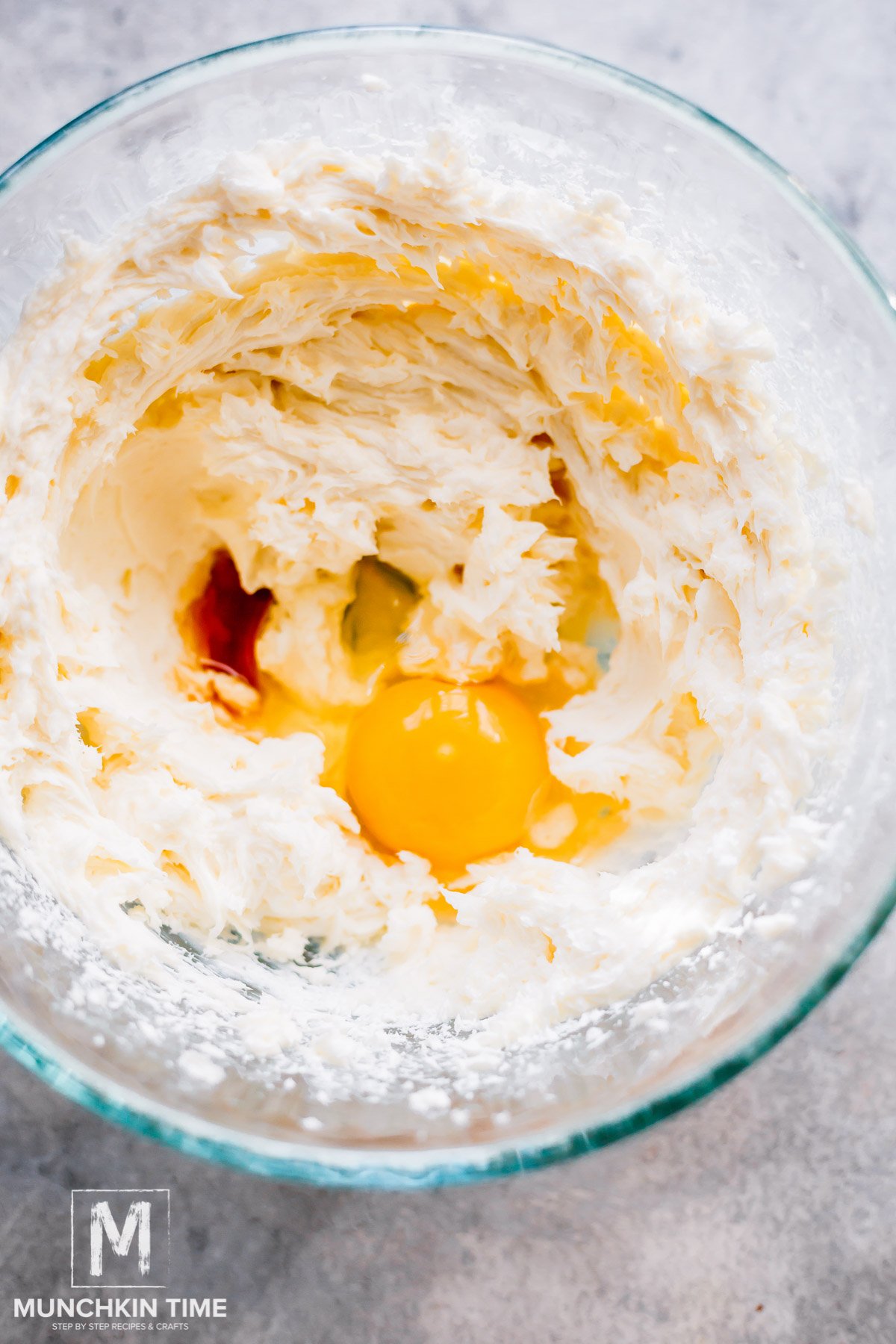 eggs and vanilla extract added to the bowl with cream cheese.