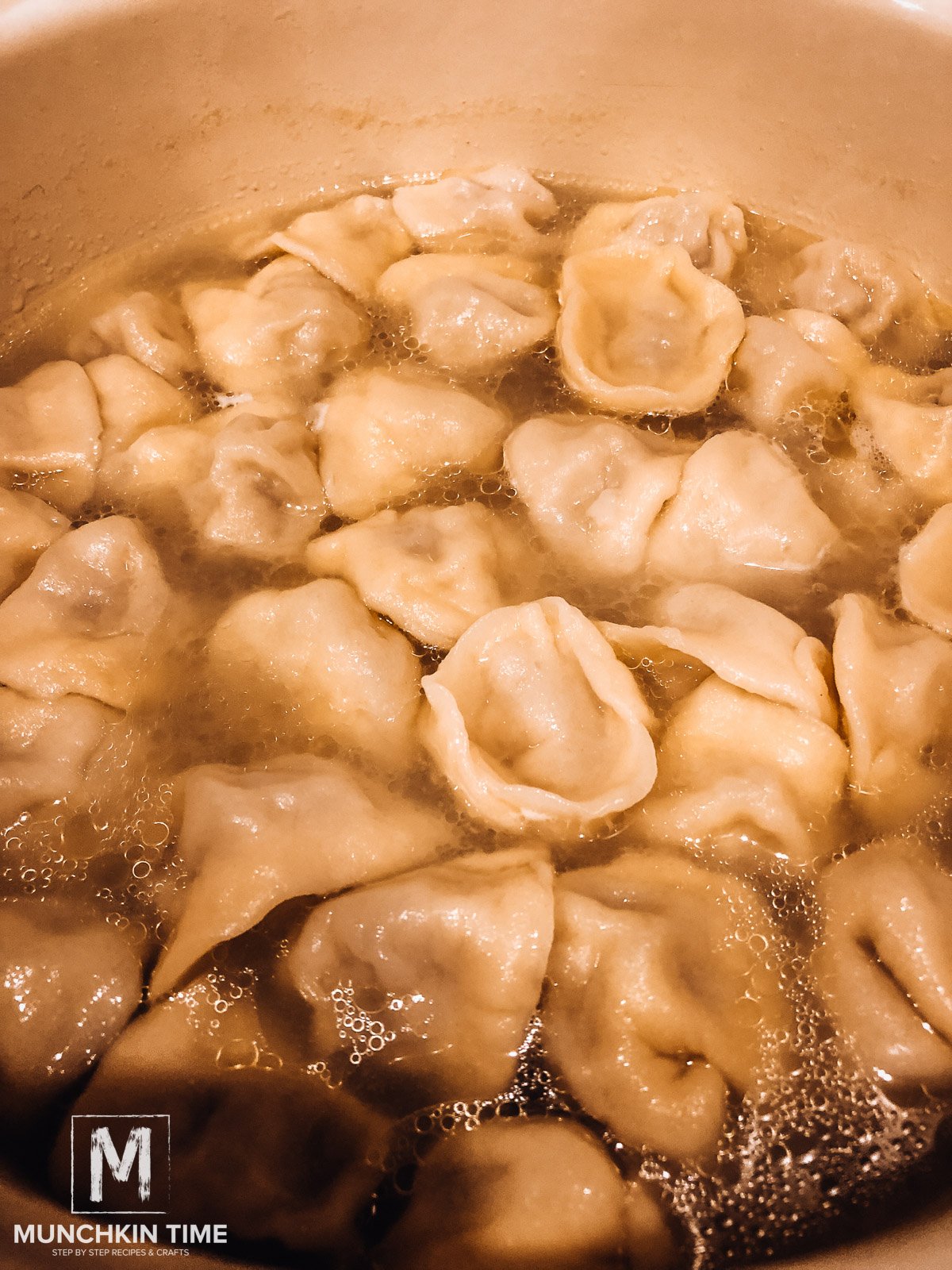 Dumplings cooking in water.