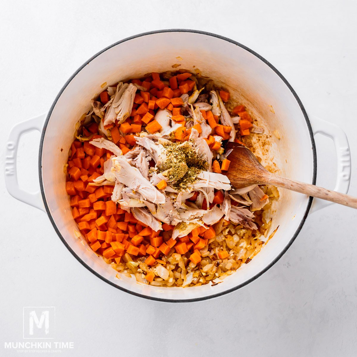 Shredded Chicken and carrots with spices added to the chicken noodle soup.
