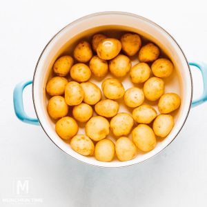 Boiled baby potatoes inside the pot.