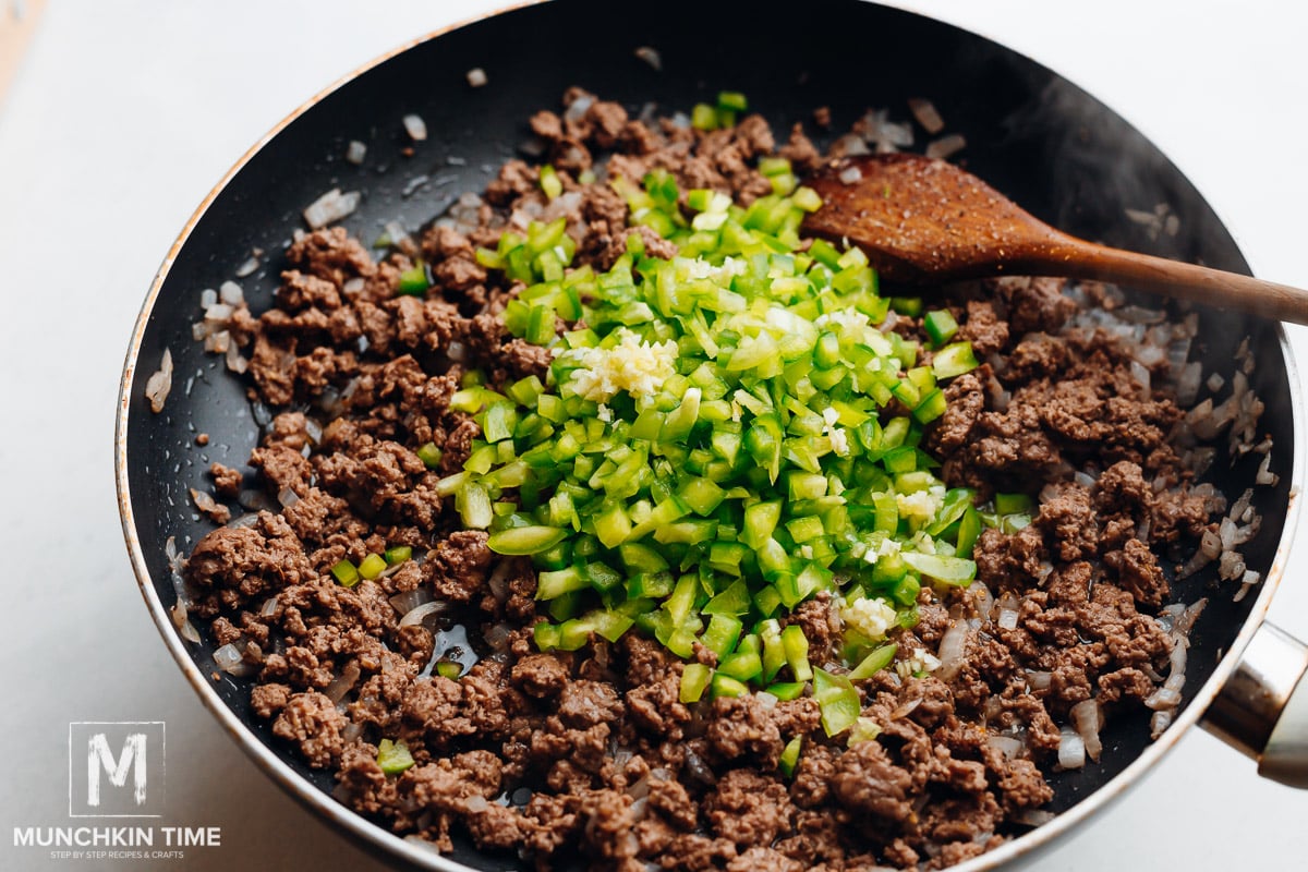 Green bell pepper and garlic added to the ground beef.