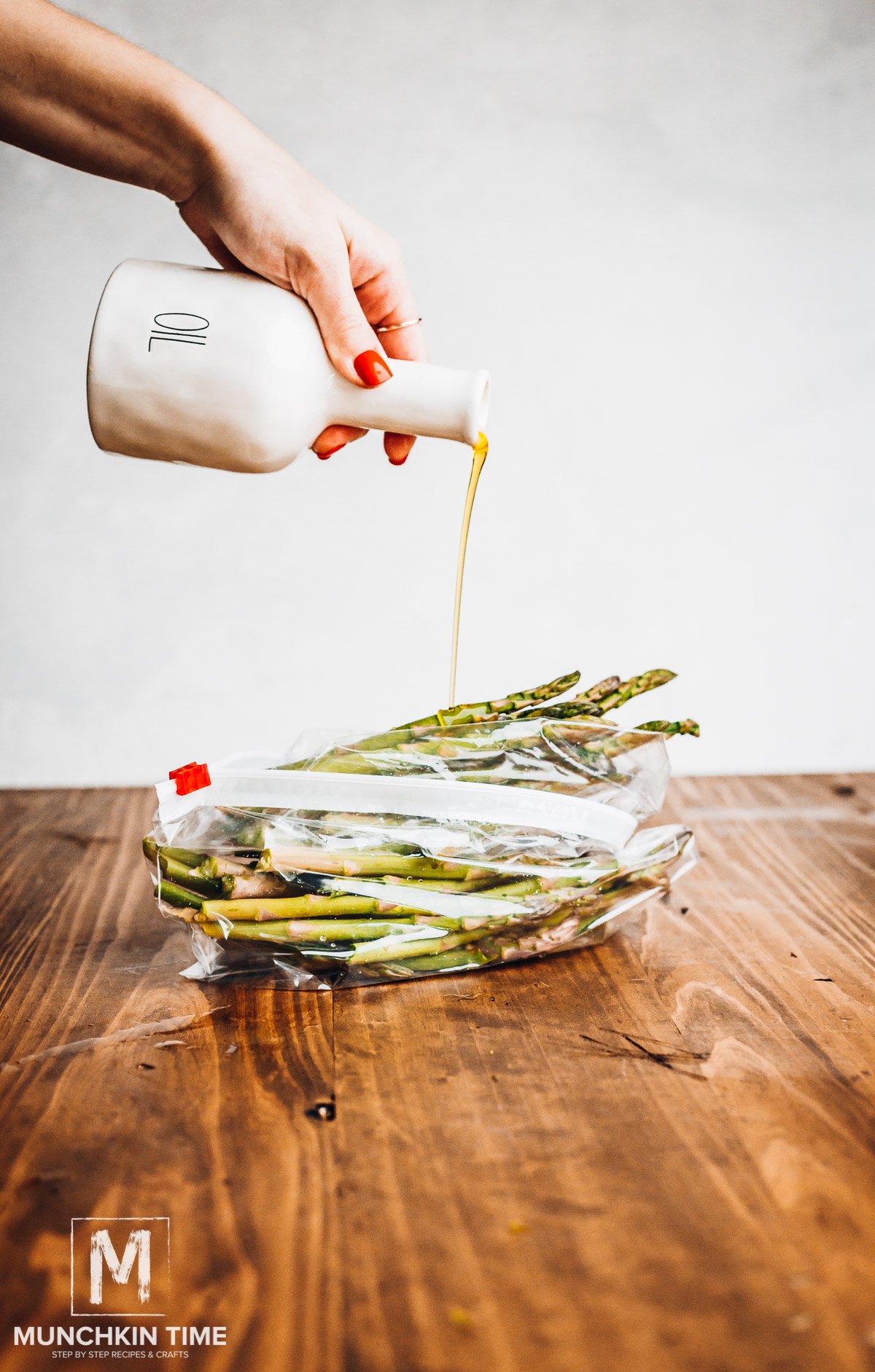 Oil drizzled over asparagus. 