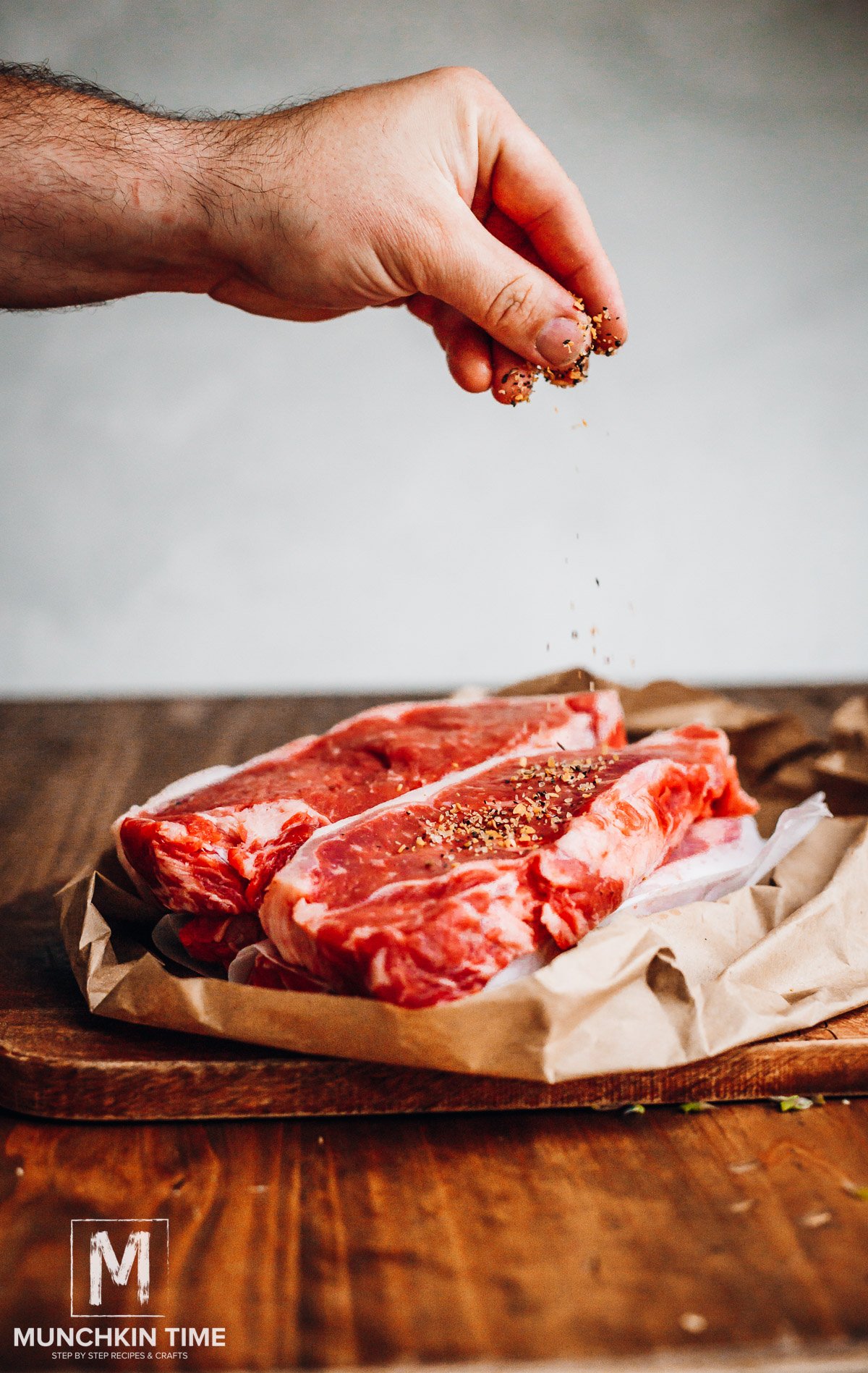 Seasoning new york strip steak with seasoning.