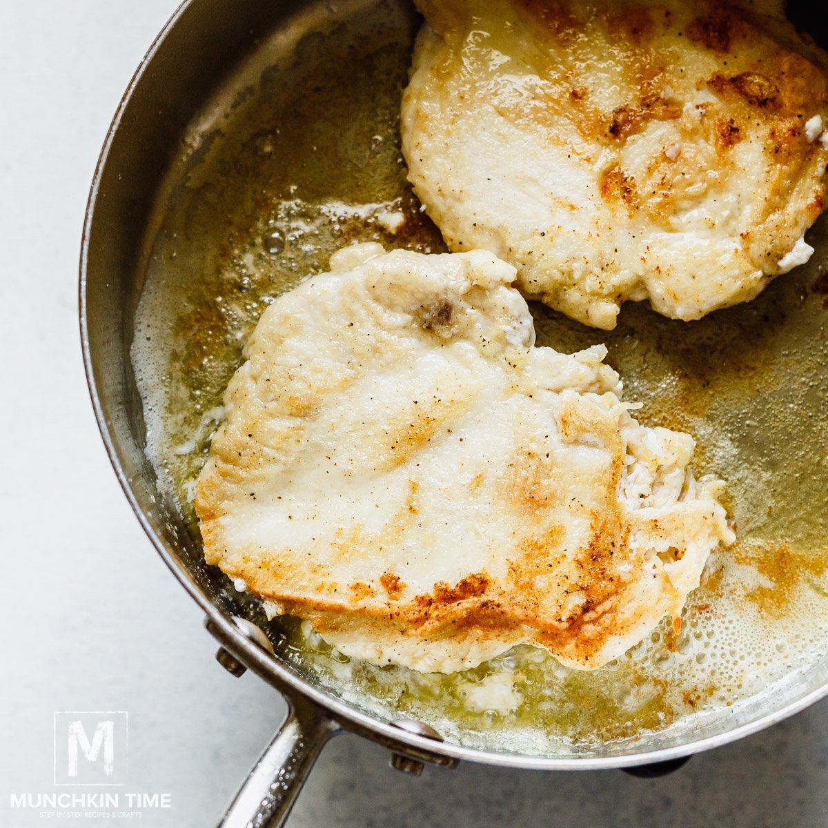 Marsala chicken saute in the skillet.