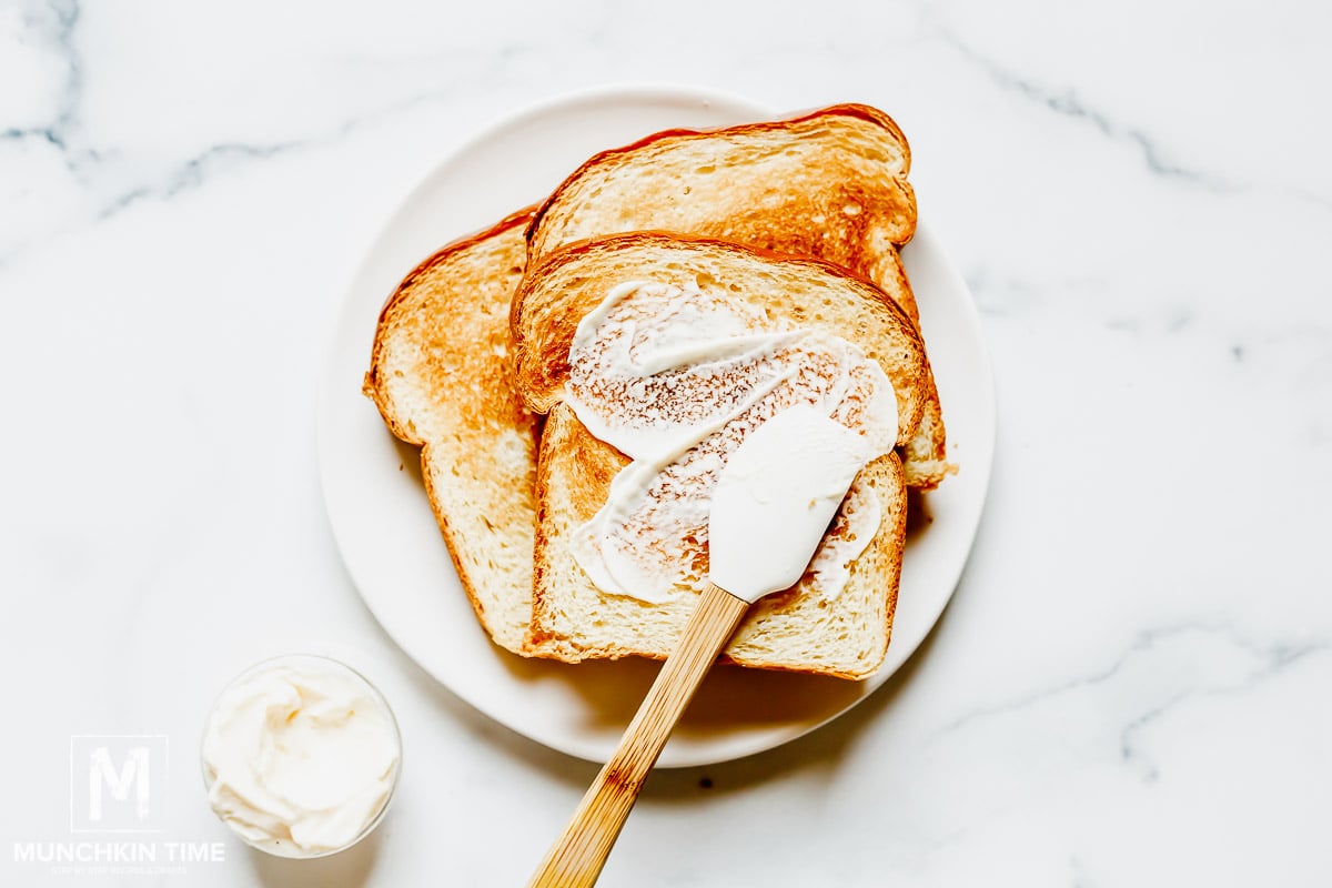 Toasted bread slices and mayo spread.