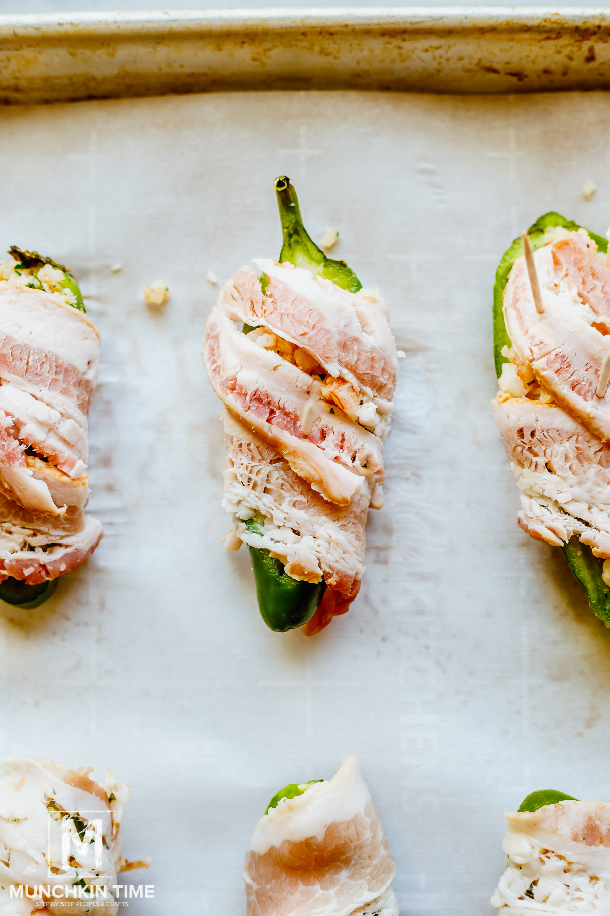Stuffed Jalapeno poppers wrapped in bacon.