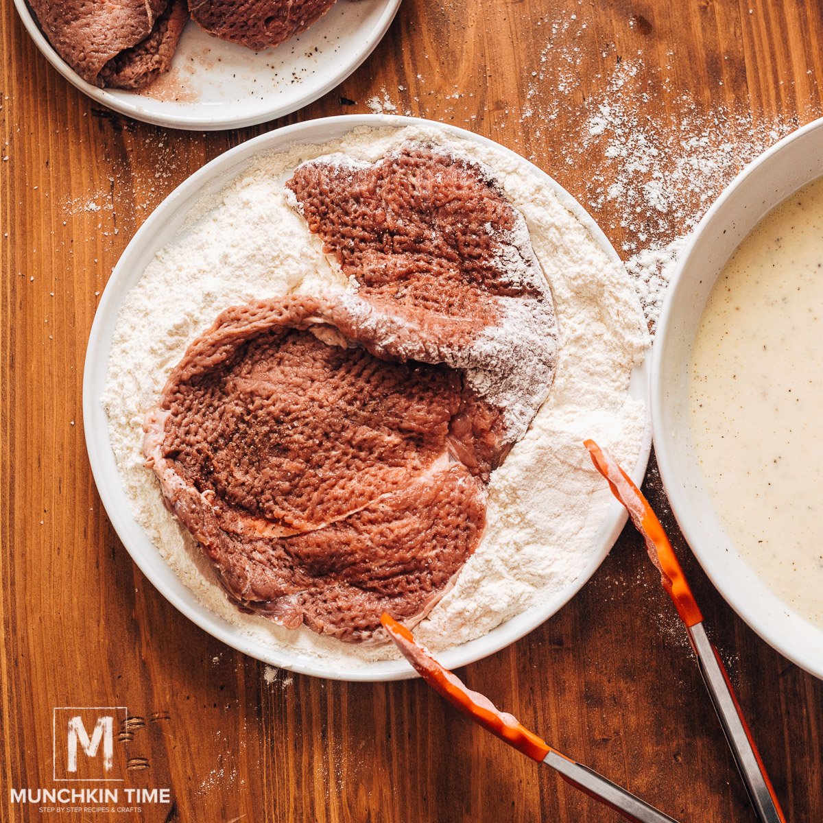 Dusting steak in the flour.