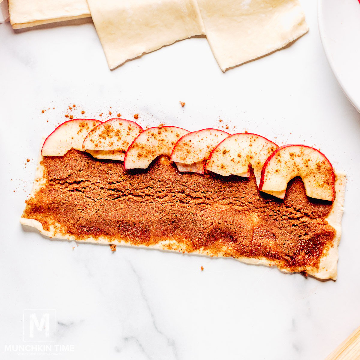 Puff pastry with cinnamon sugar and apple slices.