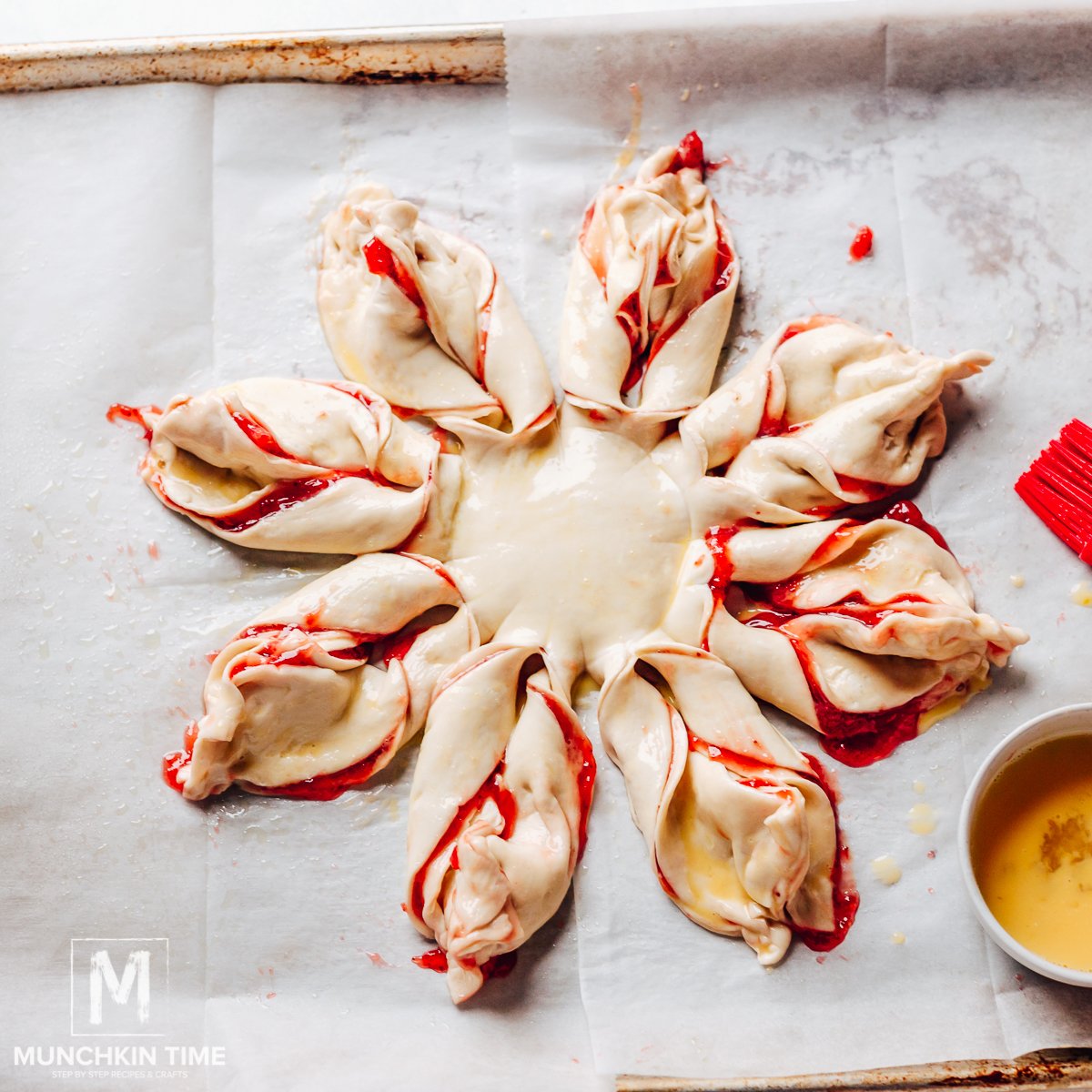 Egg wash spread over the puff pastry dessert.