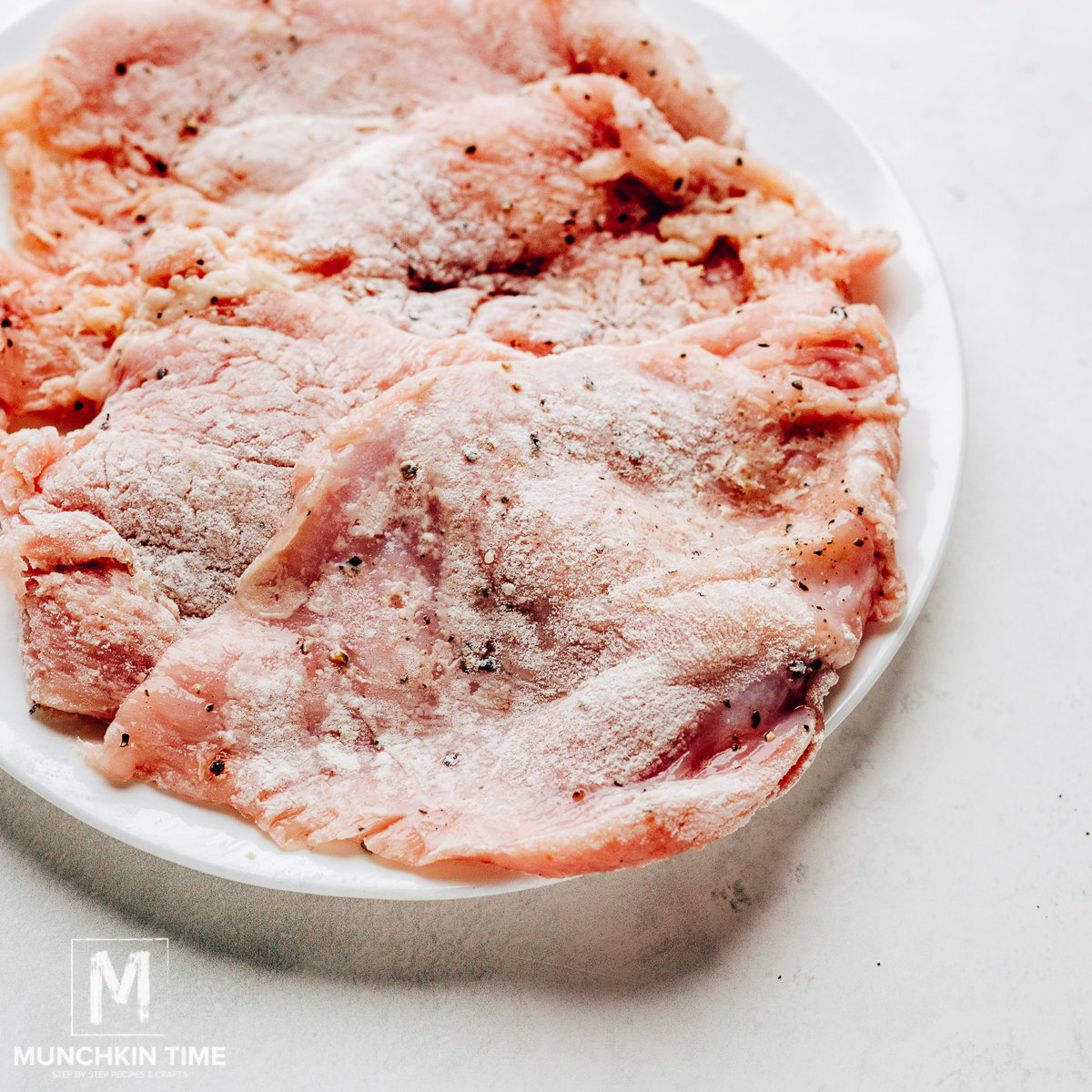 Coat each chicken side with flour