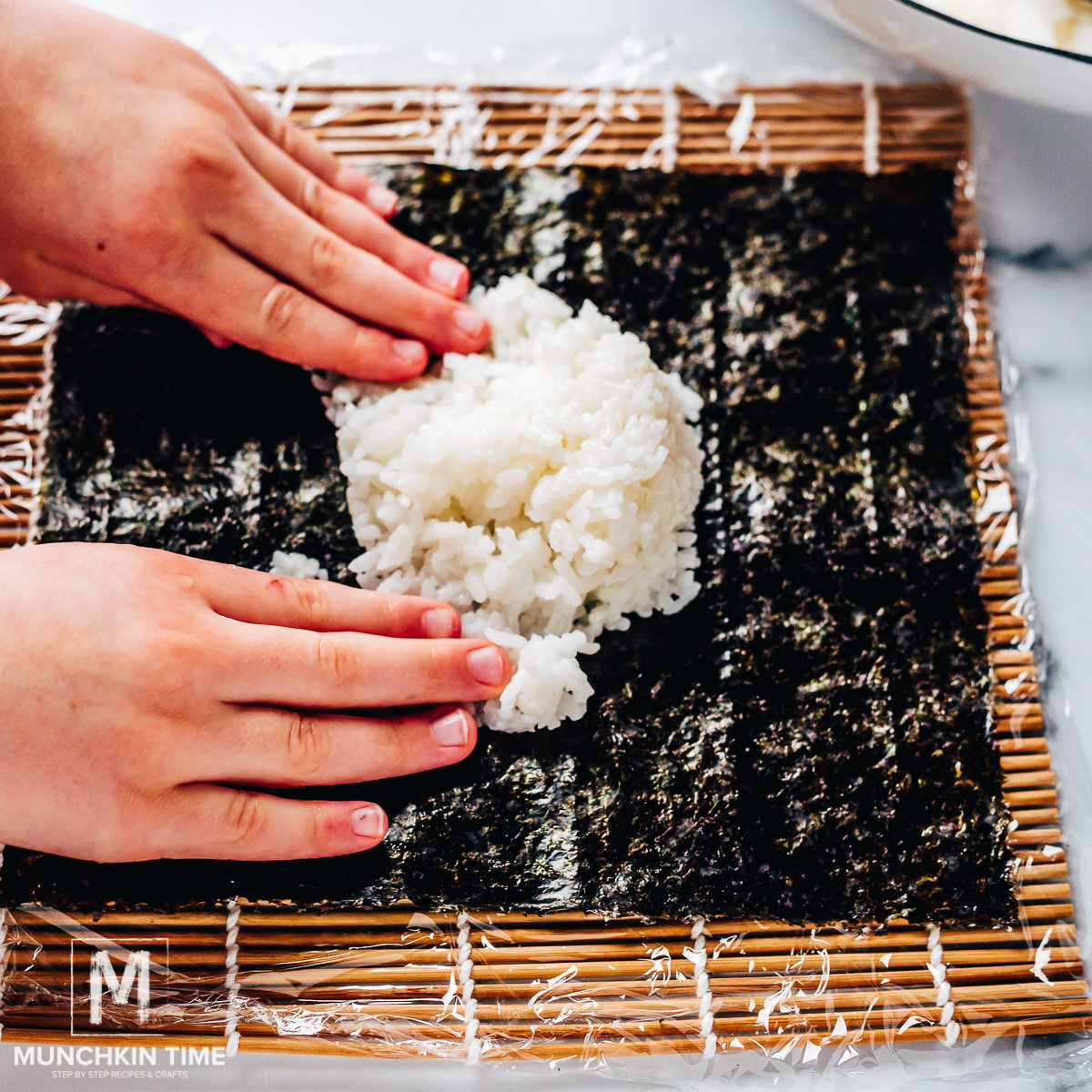 Put a piece of plastic wrap over your sushi mat