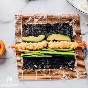 Flip the nori and add the shrimp, cucumber, and avocado to the other side.