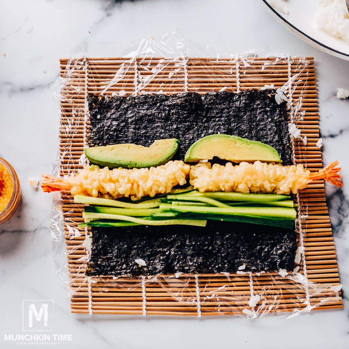 Flip the nori and add the shrimp, cucumber, and avocado to the other side.