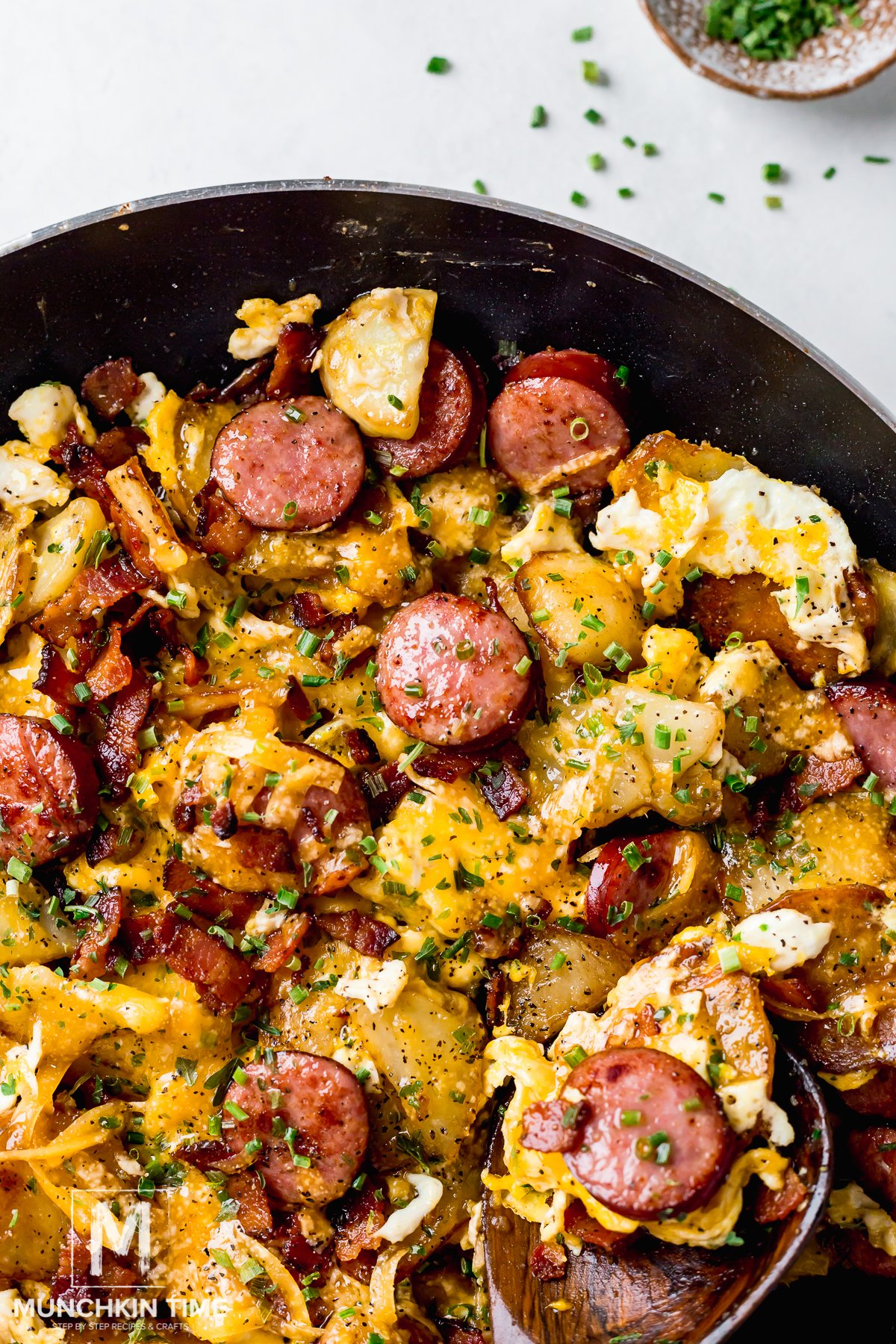 fried potatoes with eggs sausage and bacon