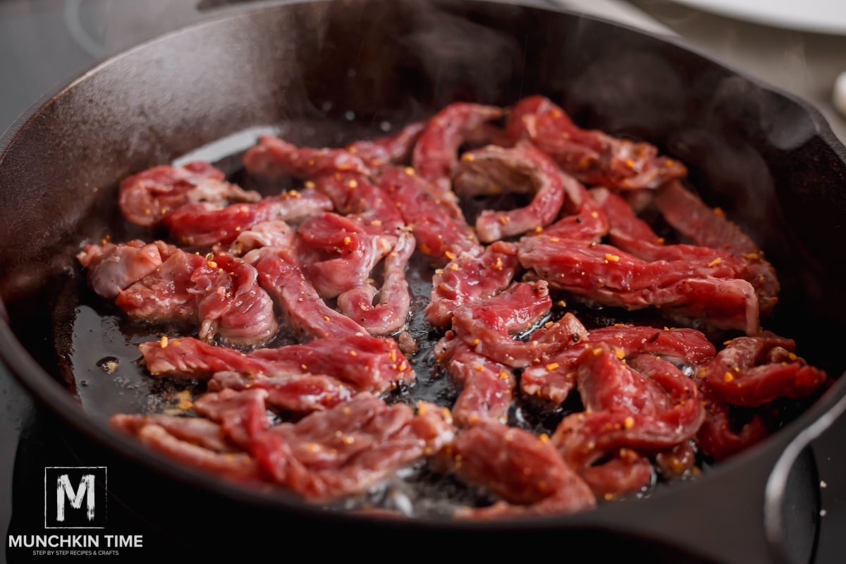 steak cooking in cast iron n a single layer