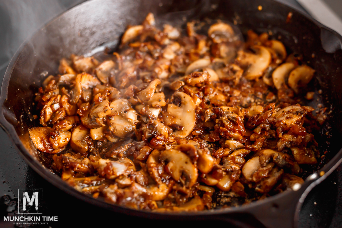 browned brown mushrooms with onion in the cast iron skillet