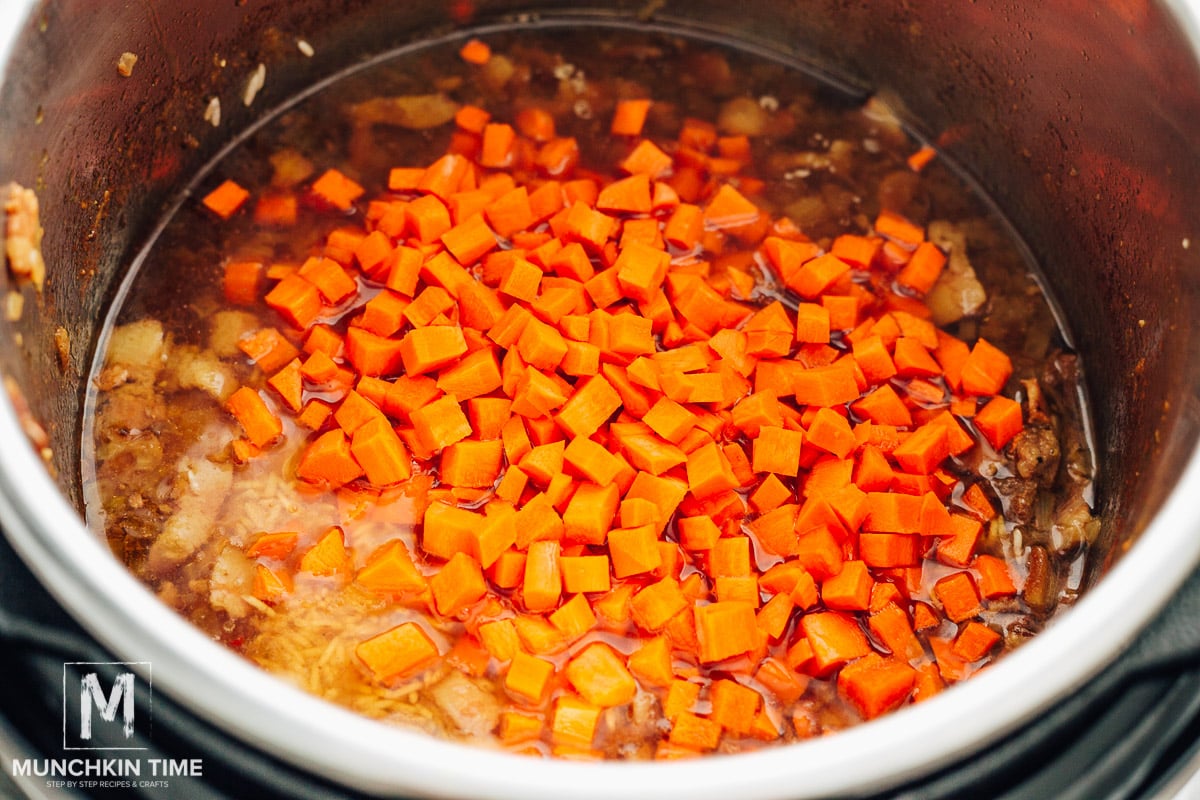 carrots and rice on top of the meat